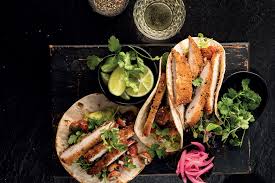 CHICKEN SCHNITZEL TACOS WITH GUACAMOLE, SALSA & SOUR CREAM DRIZZLE